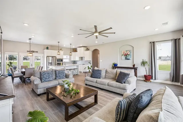 a living room with furniture and a large window