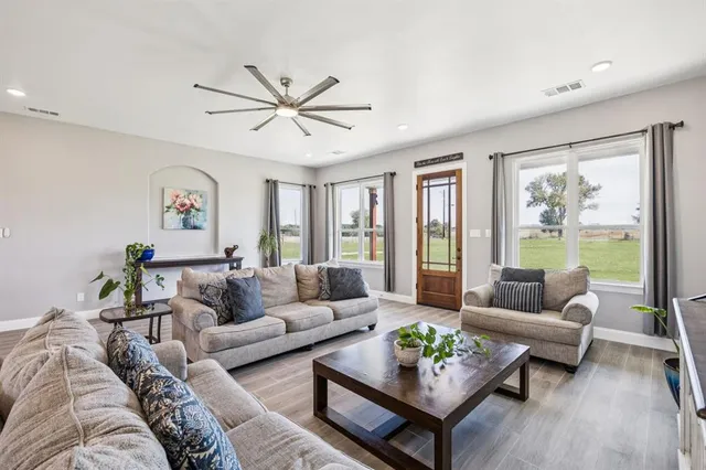 a living room with furniture and a large window