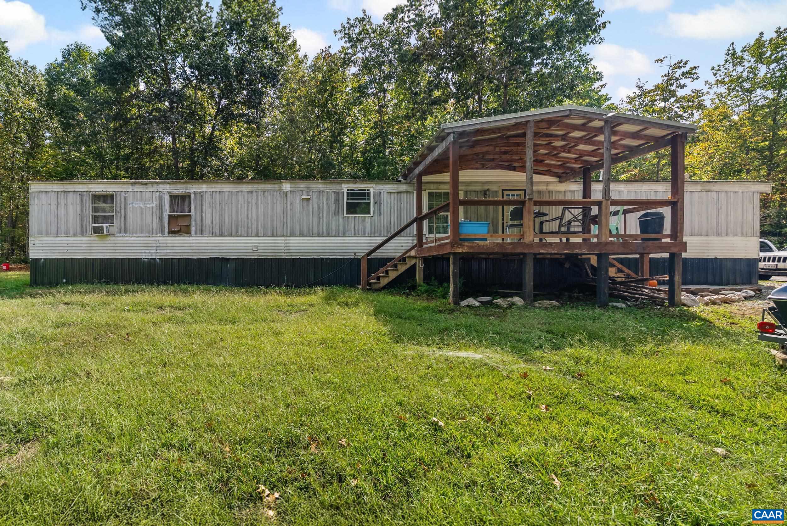 a view of a house with a yard and sitting area