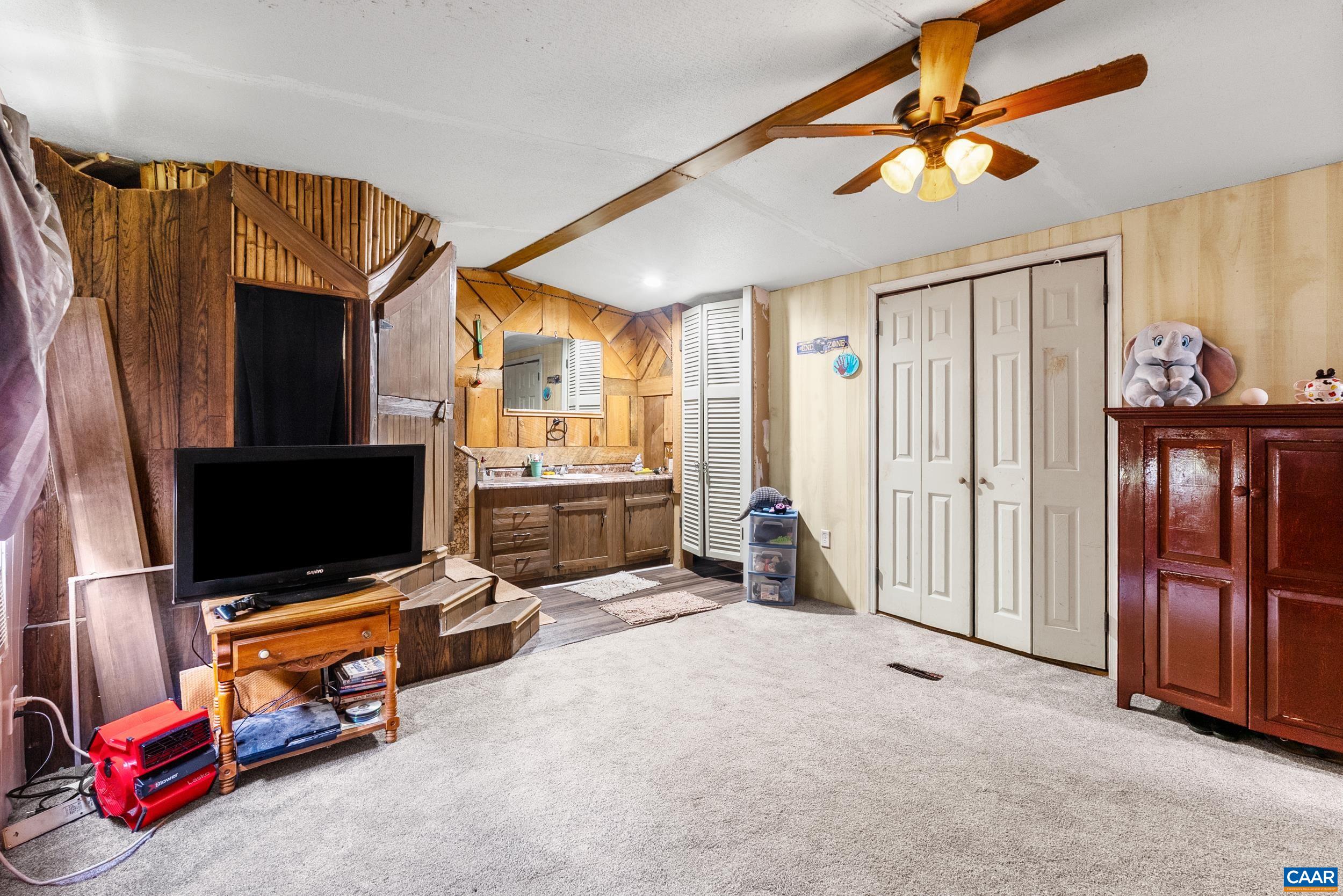386 Cub Creek Road Appomattox, VA 24522 - Photo 12 of 44 a living room with furniture and a flat screen tv