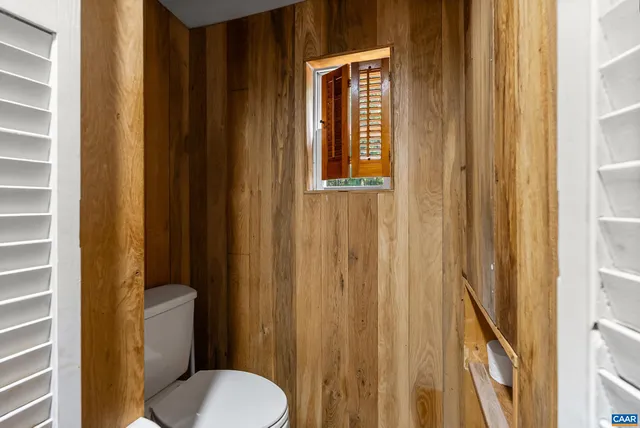 a white toilet sitting next to a bathroom