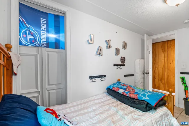 a bedroom with bed and a window