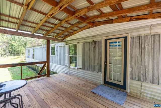 a backyard of a house with barbeque oven and trees