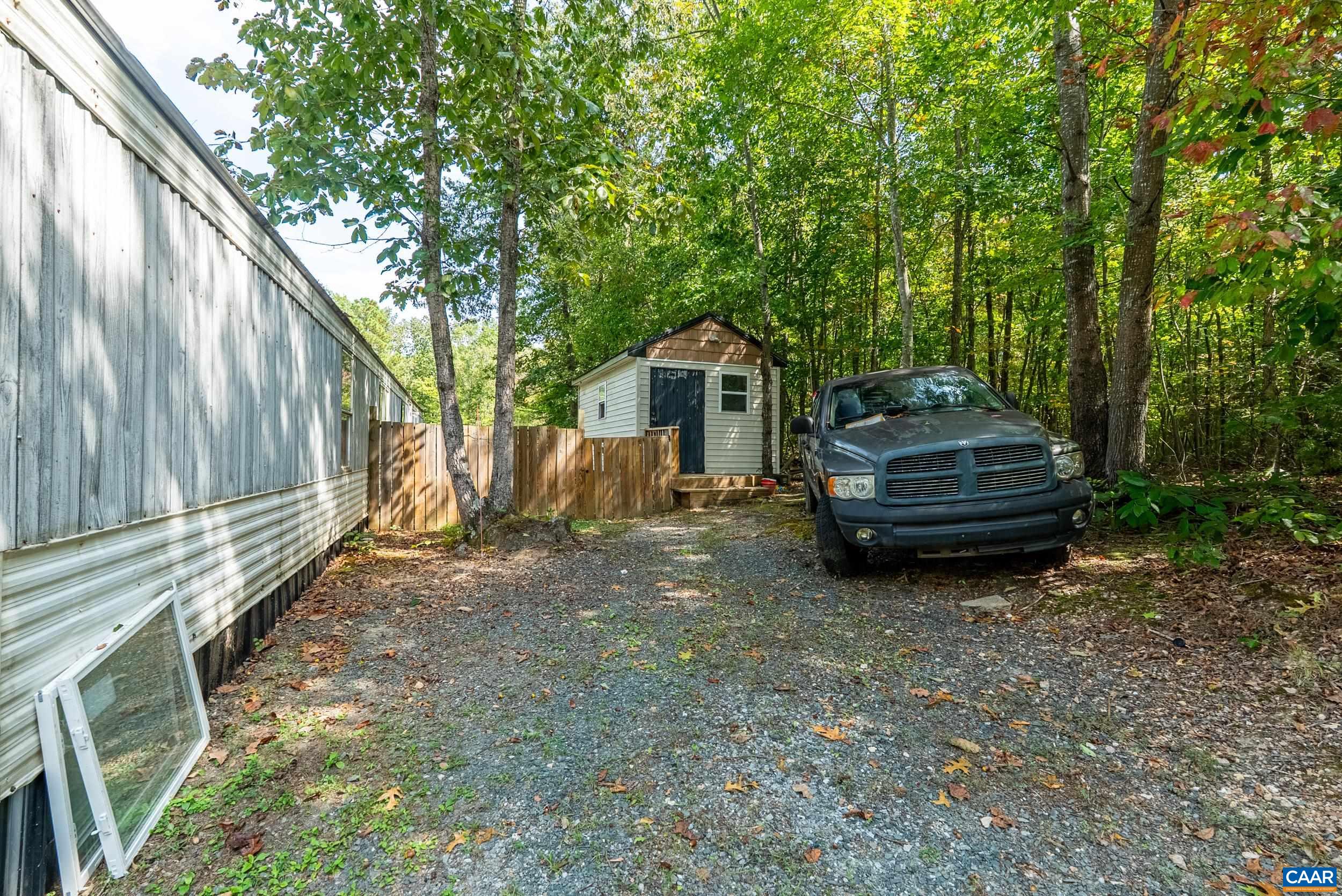 386 Cub Creek Road Appomattox, VA 24522 - Photo 35 of 44 a backyard of a house with barbeque oven and trees