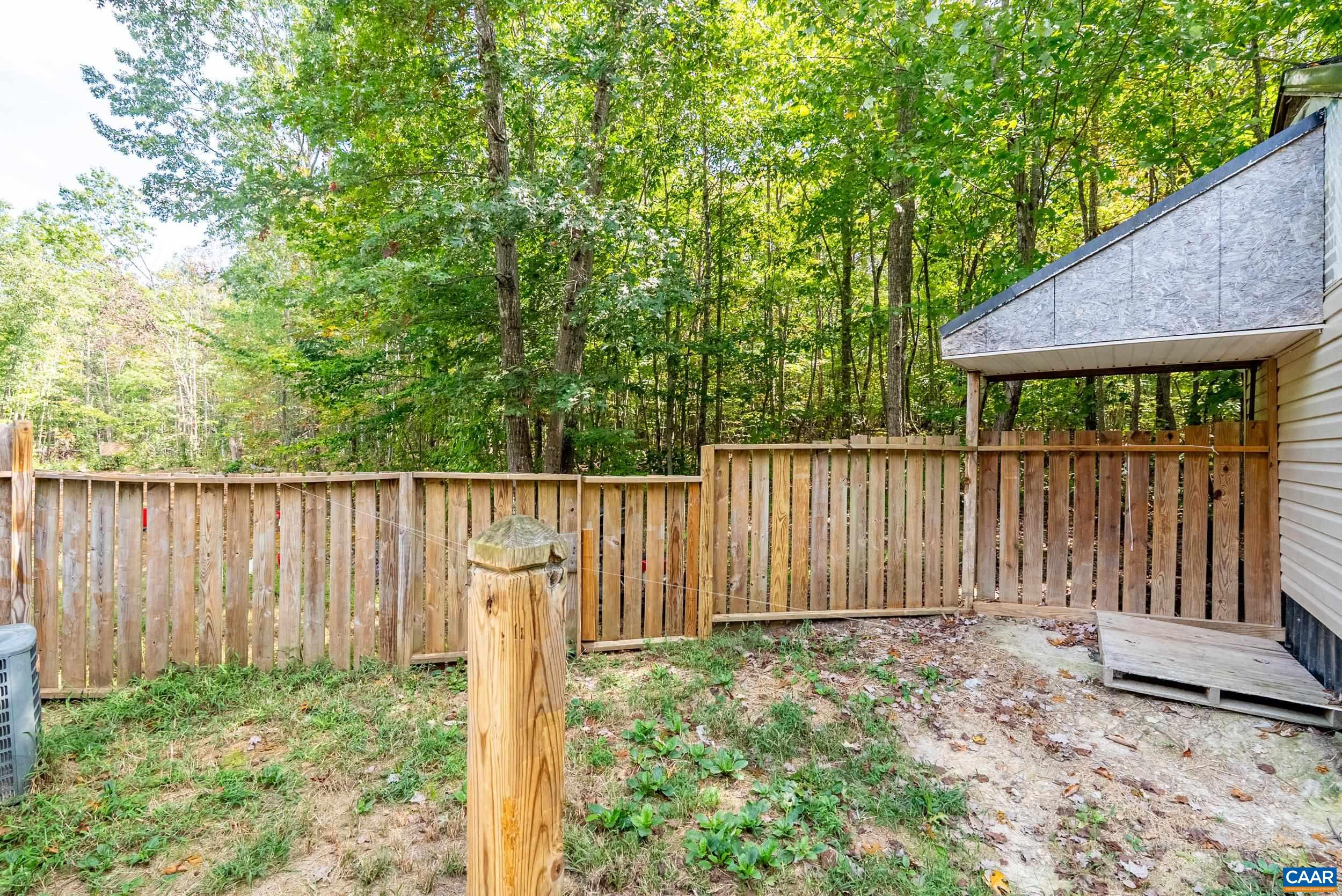 386 Cub Creek Road Appomattox, VA 24522 - Photo 36 of 44 a wooden fence with trees in the background