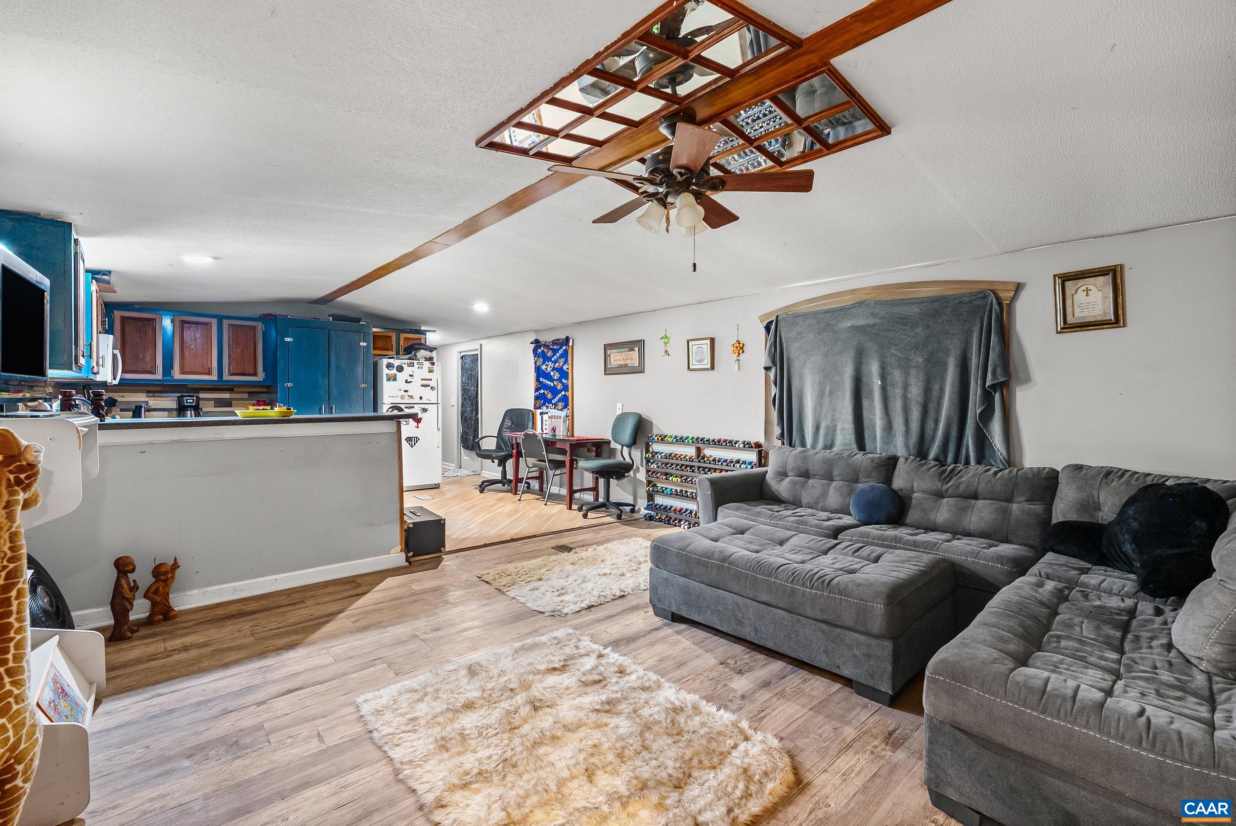 386 Cub Creek Road Appomattox, VA 24522 - Photo 4 of 44 a living room with furniture and a dining table with kitchen view
