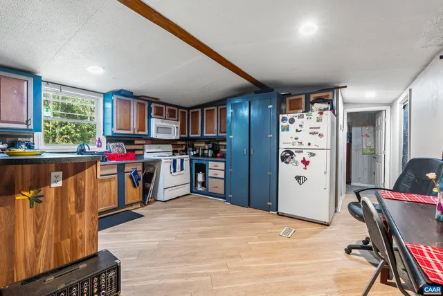 a kitchen with stainless steel appliances kitchen island granite countertop a refrigerator and a stove top oven