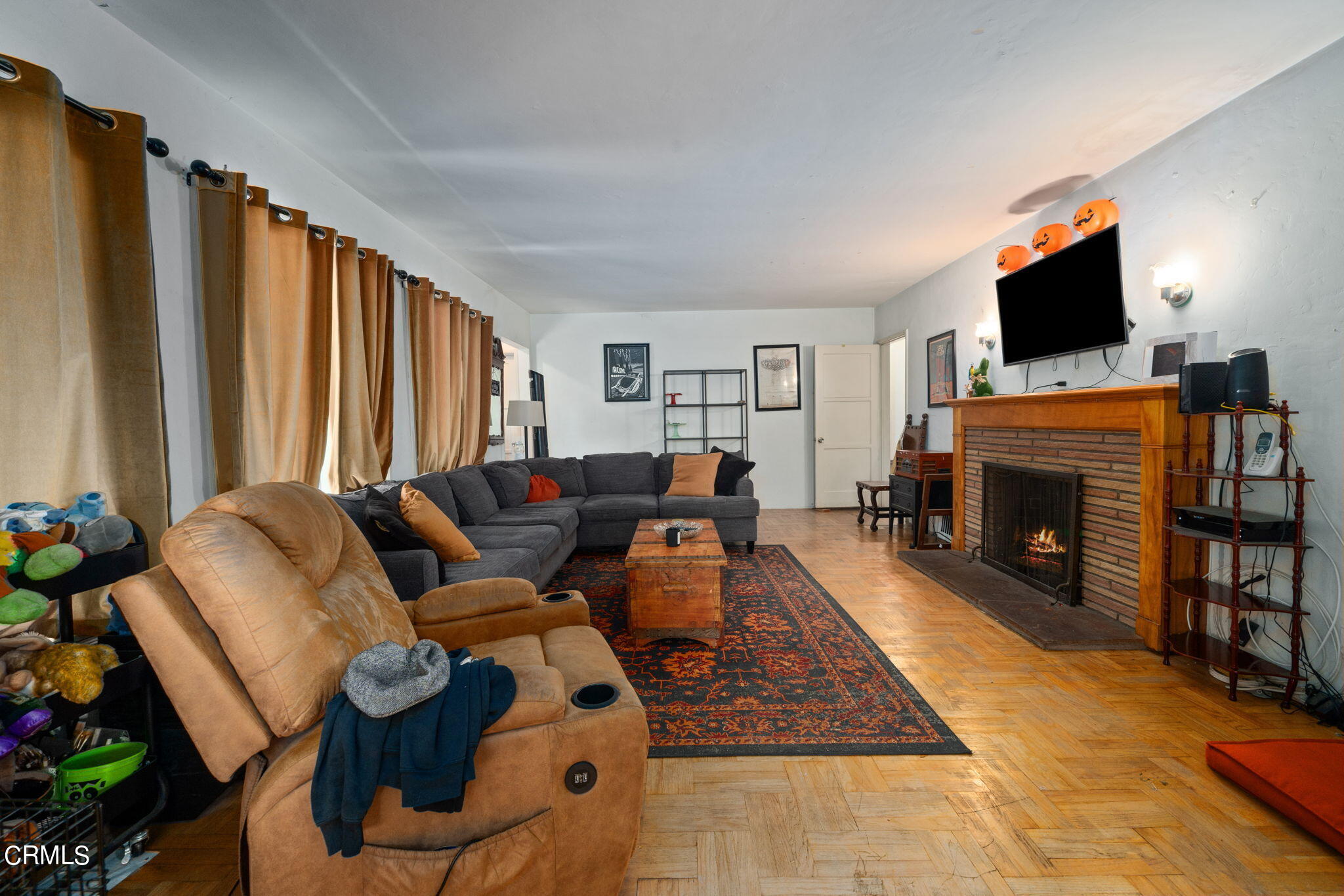 375 West Duarte Road Arcadia, CA 91007 - Photo 4 of 13 a living room with furniture a flat screen tv and a fireplace