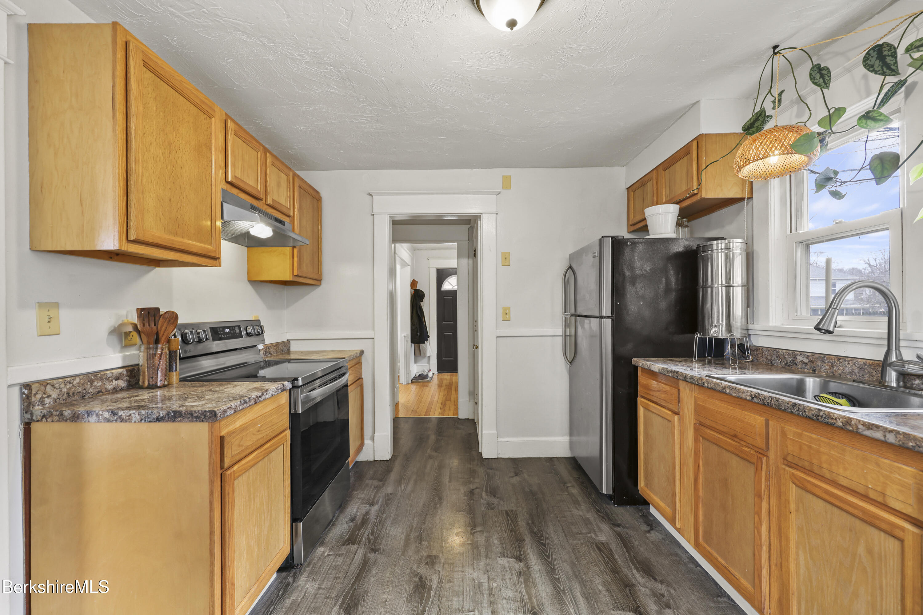 27 Morgan Street Pittsfield, MA 01201 - Photo 14 of 33 a kitchen with stainless steel appliances granite countertop a sink stove and refrigerator