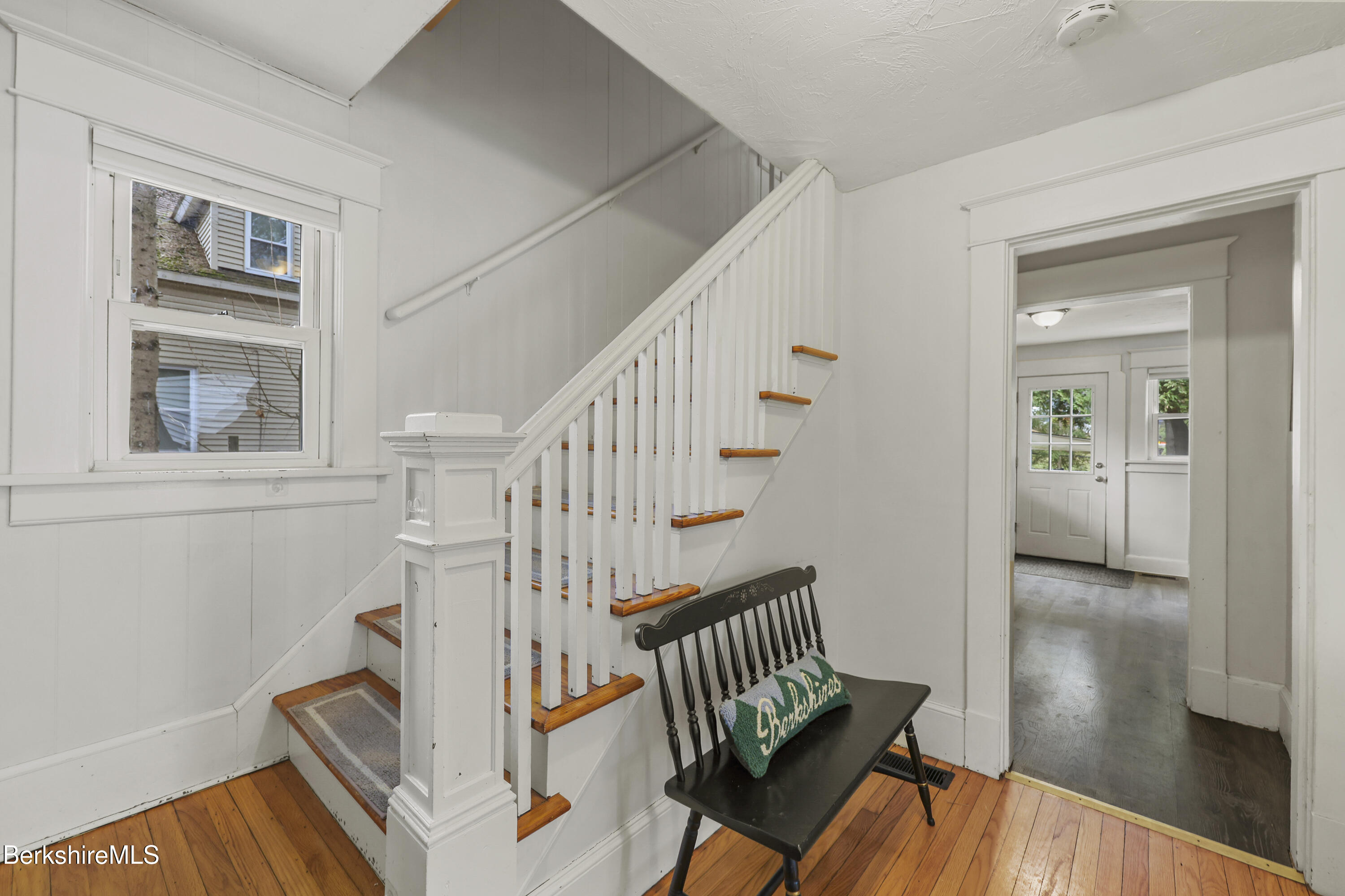 27 Morgan Street Pittsfield, MA 01201 - Photo 5 of 33 a view of a hallway with wooden floor and stairs