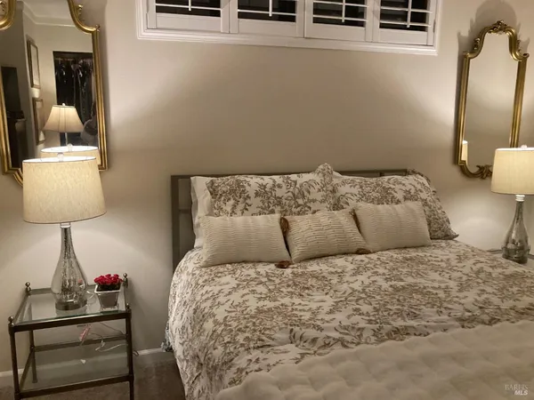 a bed sitting in a bedroom next to a window