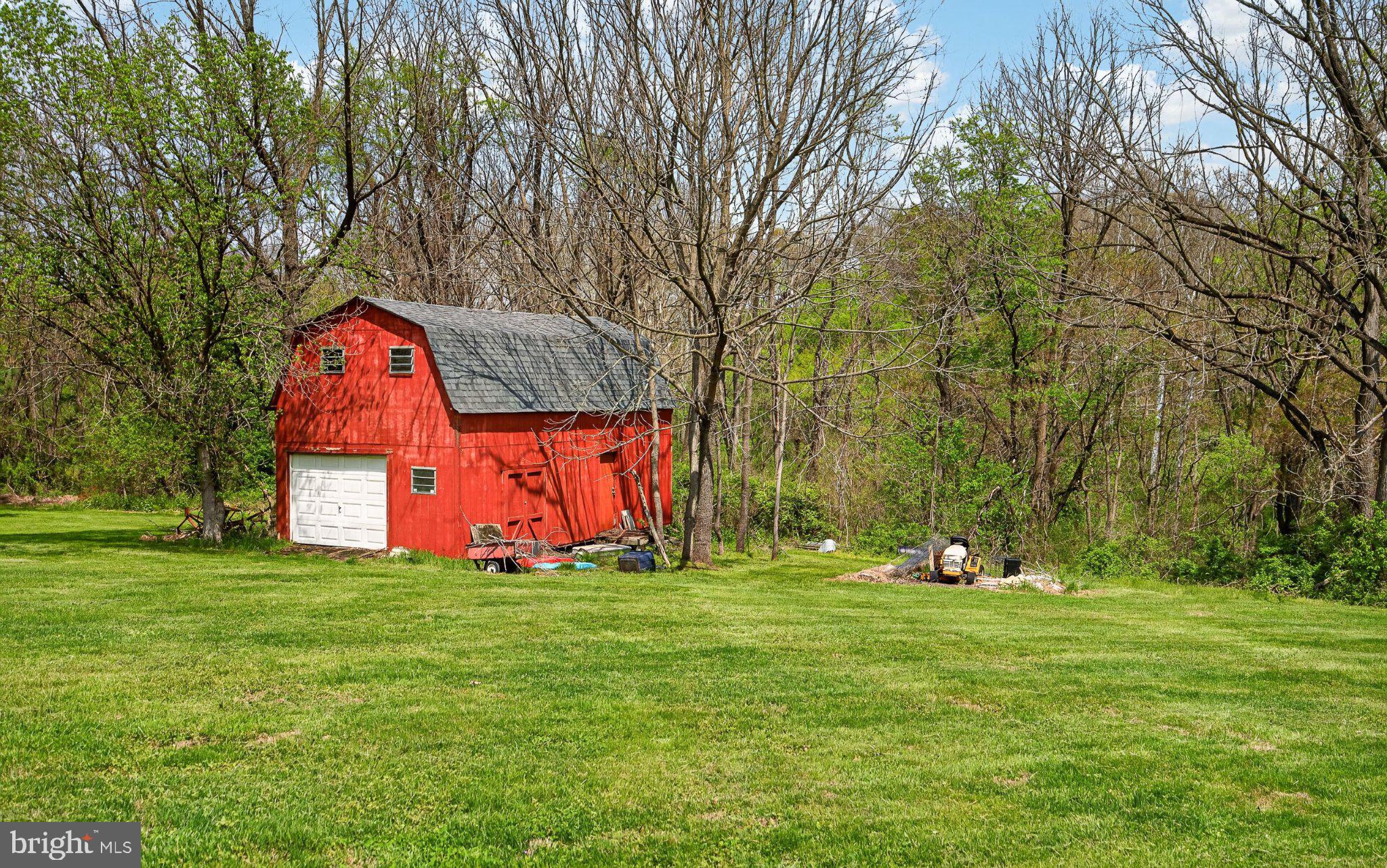 45 Latham Road Nottingham, PA 19362 - Photo 53 of 80 Charming red barn amidst lush greenery.