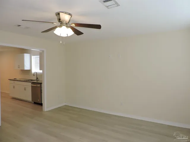 a view of a kitchen with a sink a stove top oven and chandelier