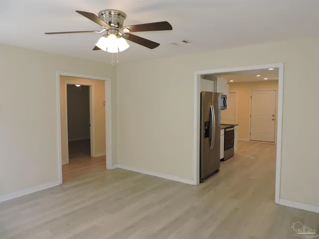 a view of a livingroom with a chandelier fan