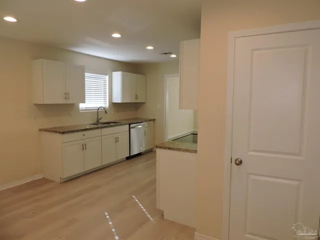 a kitchen with a sink and cabinets
