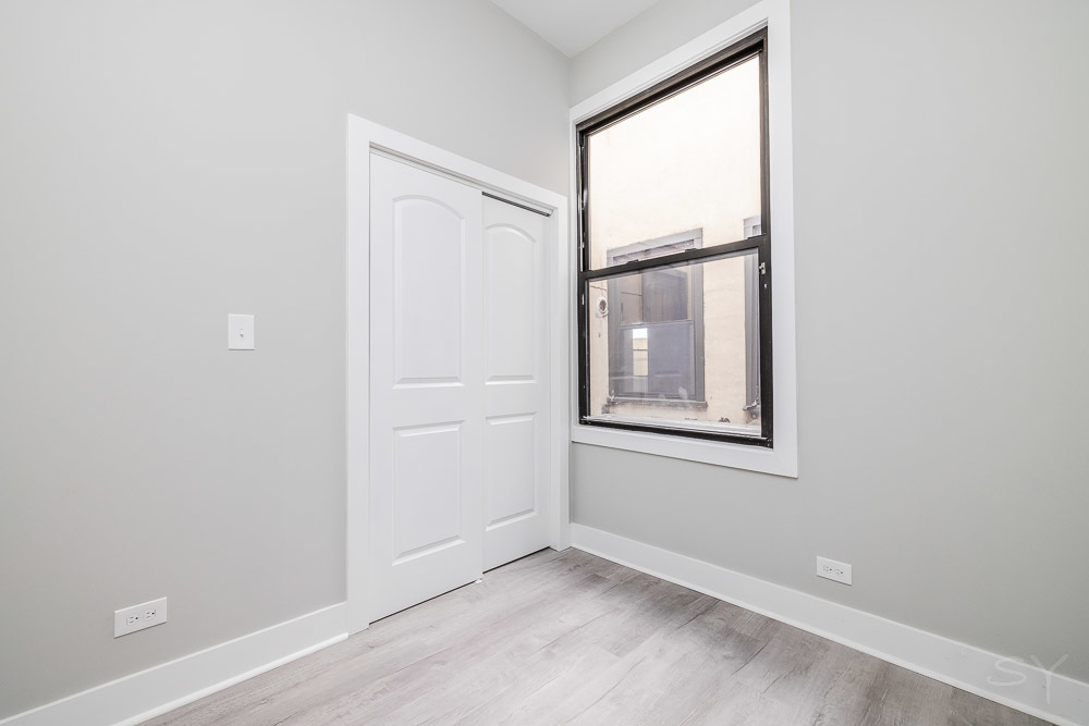 2448 South Oakley Avenue, Unit 2F Chicago, IL 60608 - Photo 13 of 14 an empty room with windows and closet