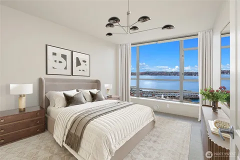 a bedroom with a large bed and a chandelier