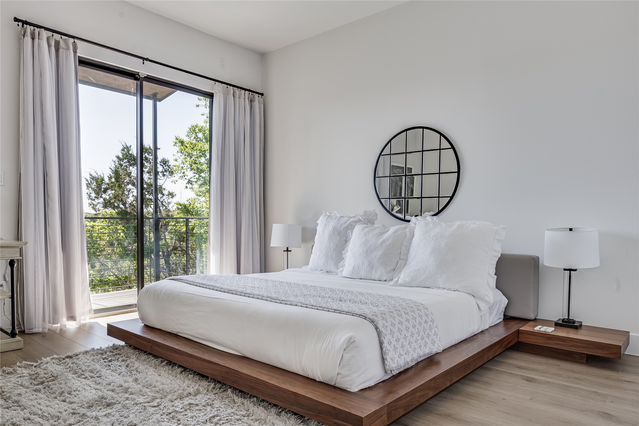 3138 Chisholm Trail Austin, TX 78734 - Photo 21 of 40 a bedroom with a bed lamp and a large window with outer view