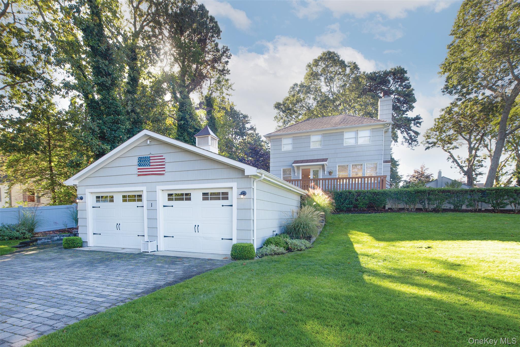 1 Canal Road Hampton Bays, NY 11946 - Photo 1 of 50 View of side of property featuring a chimney, an outbuilding, and a garage