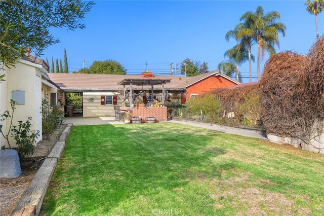 a view of a patio with table and chairs under an umbrella