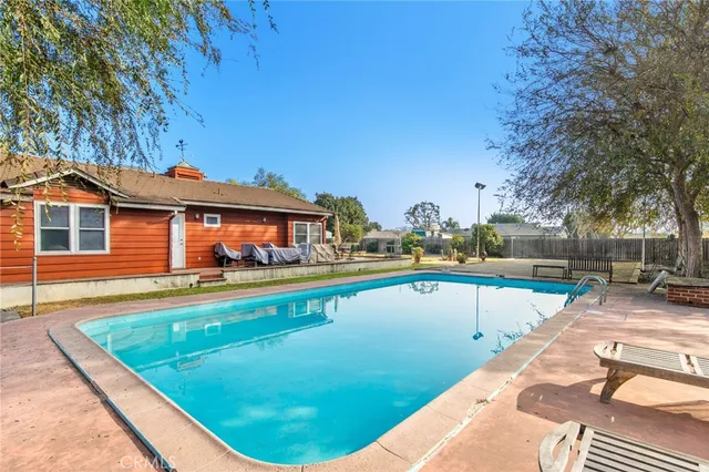 a view of a swimming pool with a lounge chairs