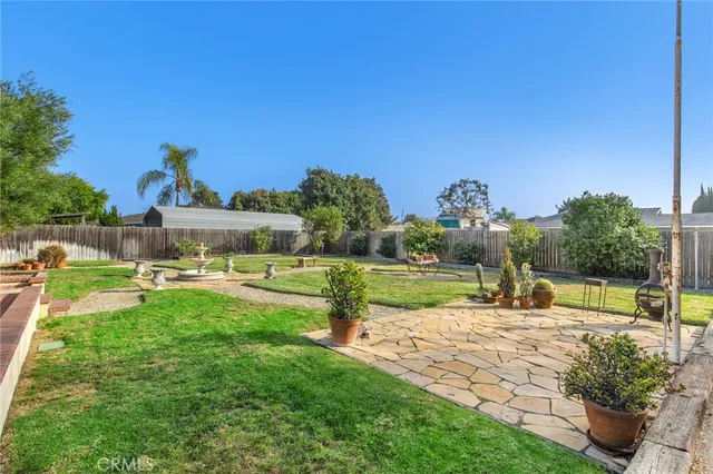 a view of a backyard with sitting area
