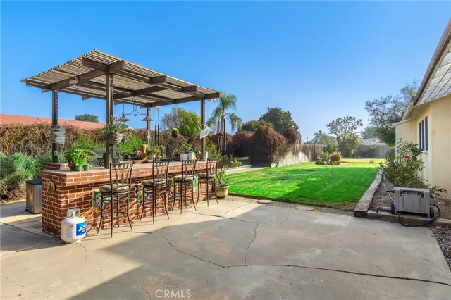 a view of a table and chairs under an umbrella