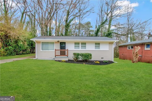 a front view of house with yard and green space