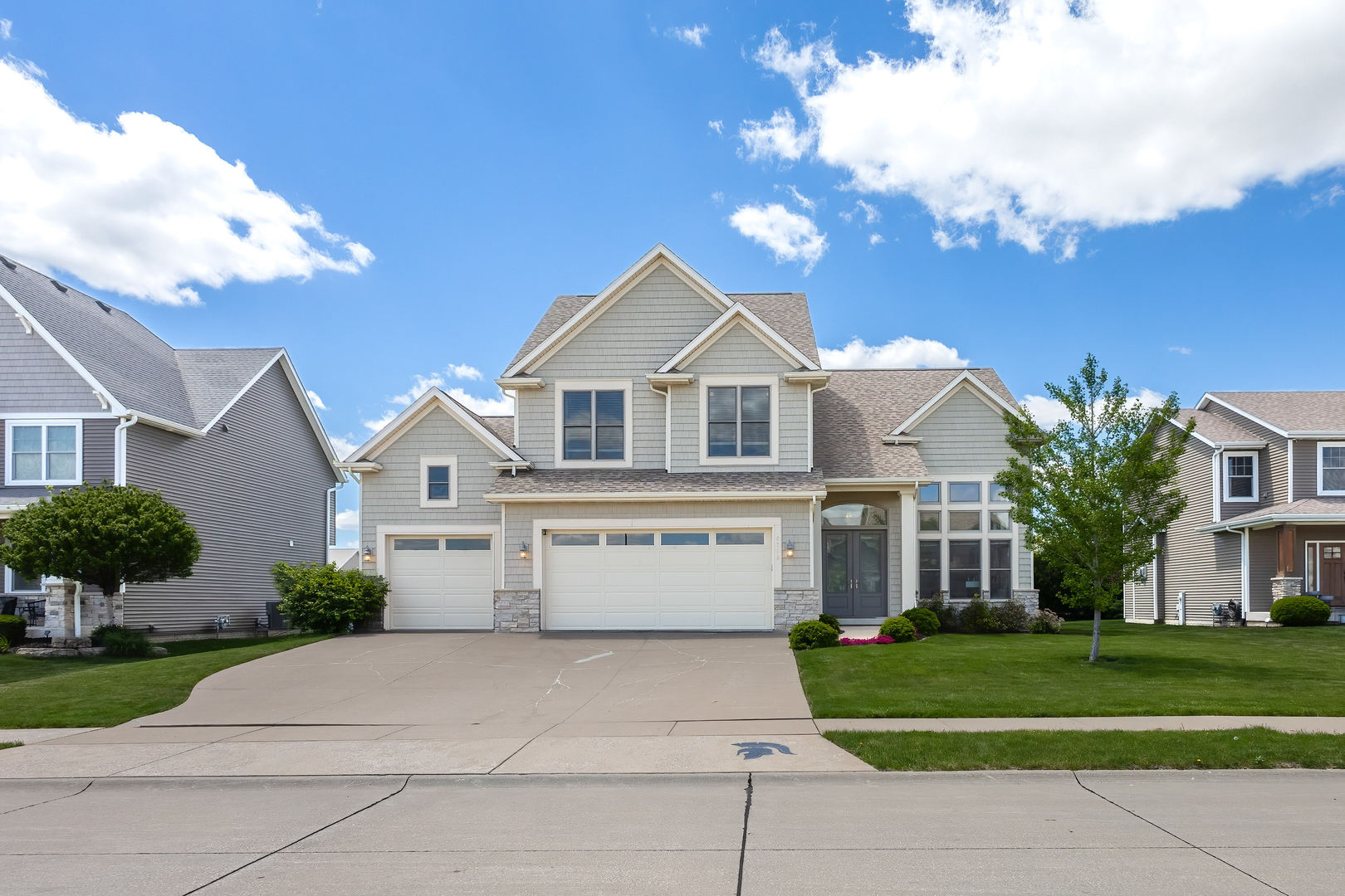 5700 Emily Road Bettendorf, IA 52722 - Photo 57 of 58 a front view of a house with a yard and trees