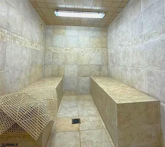 a bedroom with two beds and a desk