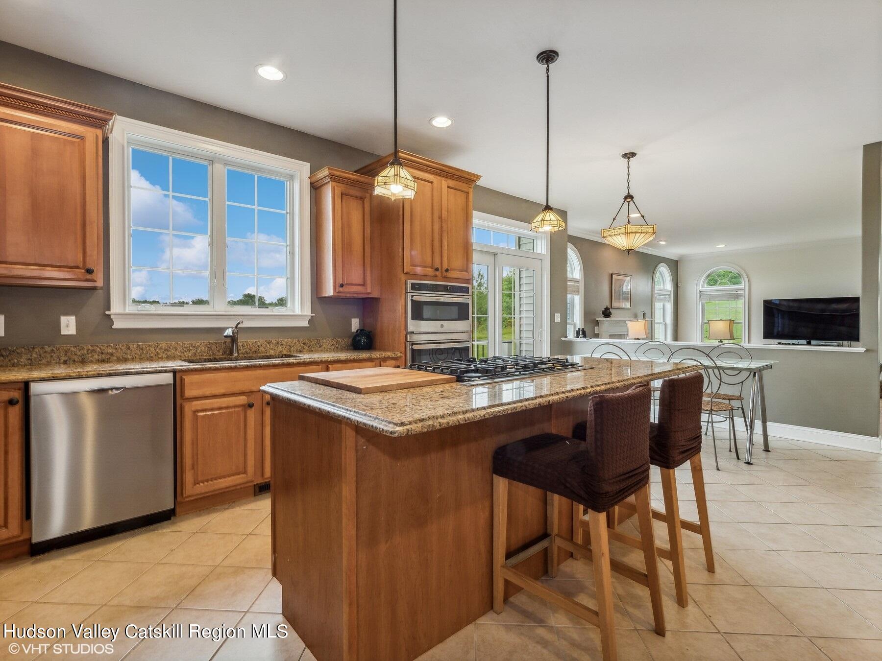 39 Ridgeline Drive Poughkeepsie, NY 12603 - Photo 12 of 35 a kitchen with stainless steel appliances granite countertop a stove a sink a oven a dining table and chairs