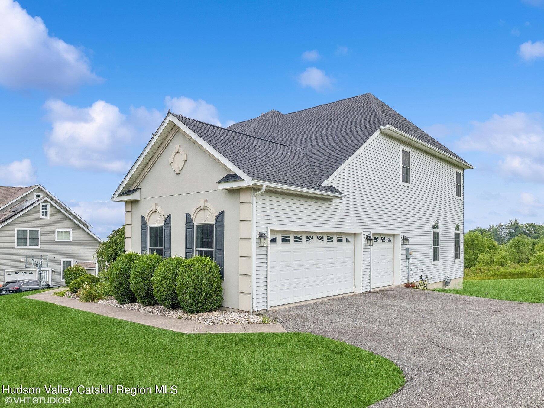 39 Ridgeline Drive Poughkeepsie, NY 12603 - Photo 2 of 35 a front view of a house with a yard and garage