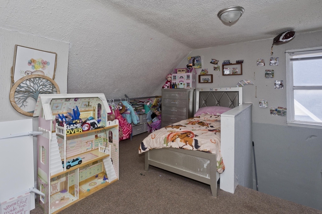 52 Orlando Street Springfield, MA 01108 - Photo 15 of 29 a bedroom with baby bed and window