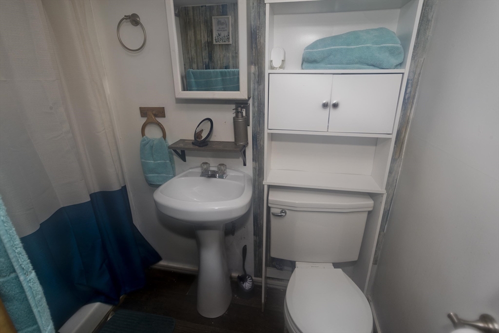 52 Orlando Street Springfield, MA 01108 - Photo 28 of 29 a bathroom with a toilet a sink and mirror