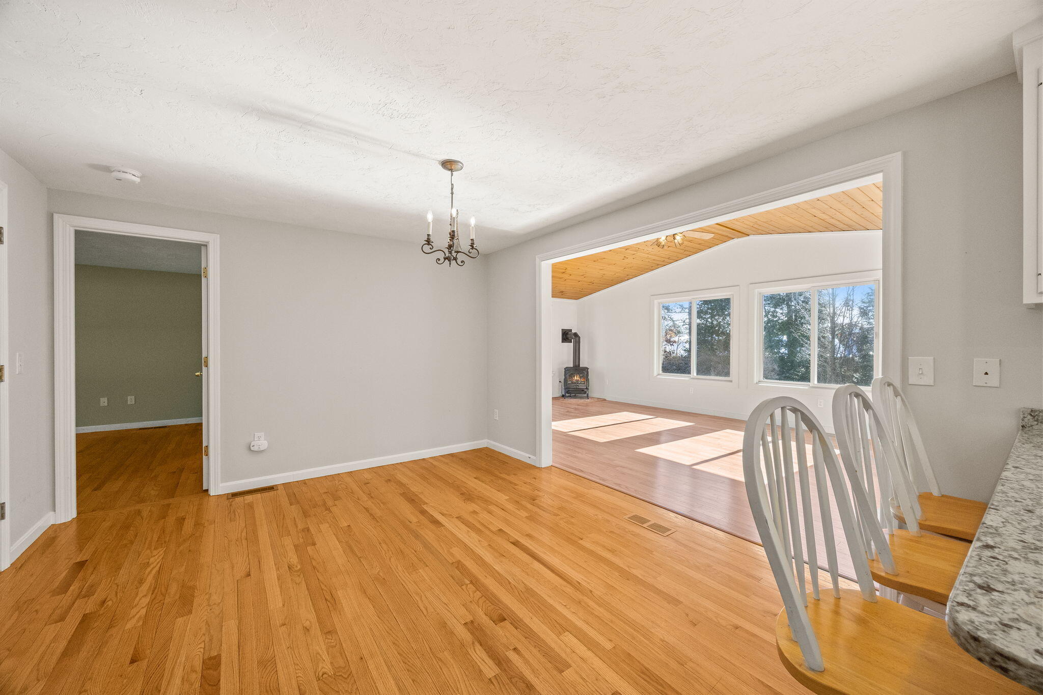 84 Middle Road South Chatham, MA 02659 - Photo 13 of 48 a view of hallway with wooden floor and chandelier