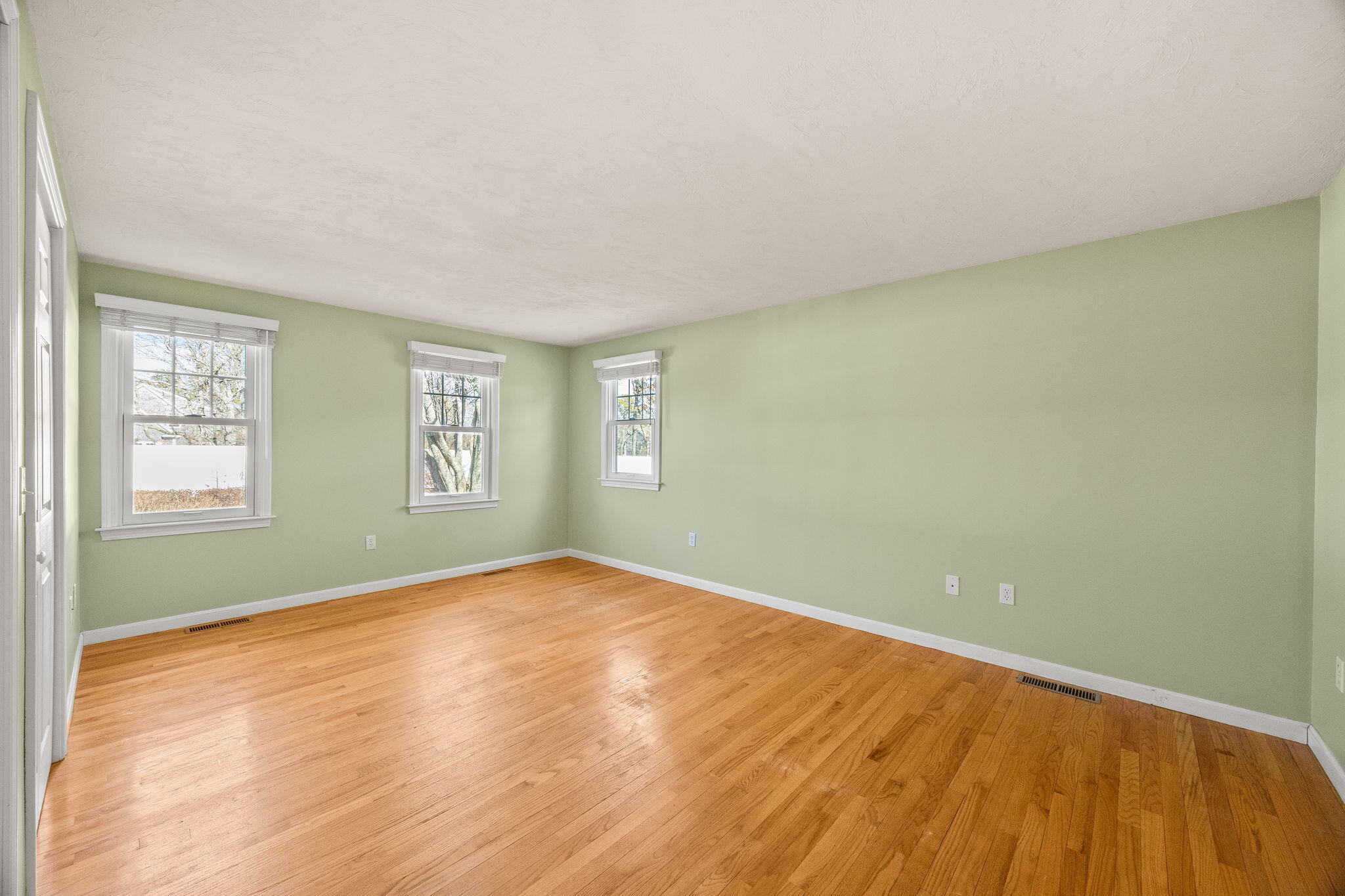 84 Middle Road South Chatham, MA 02659 - Photo 18 of 48 an empty room with wooden floor and windows