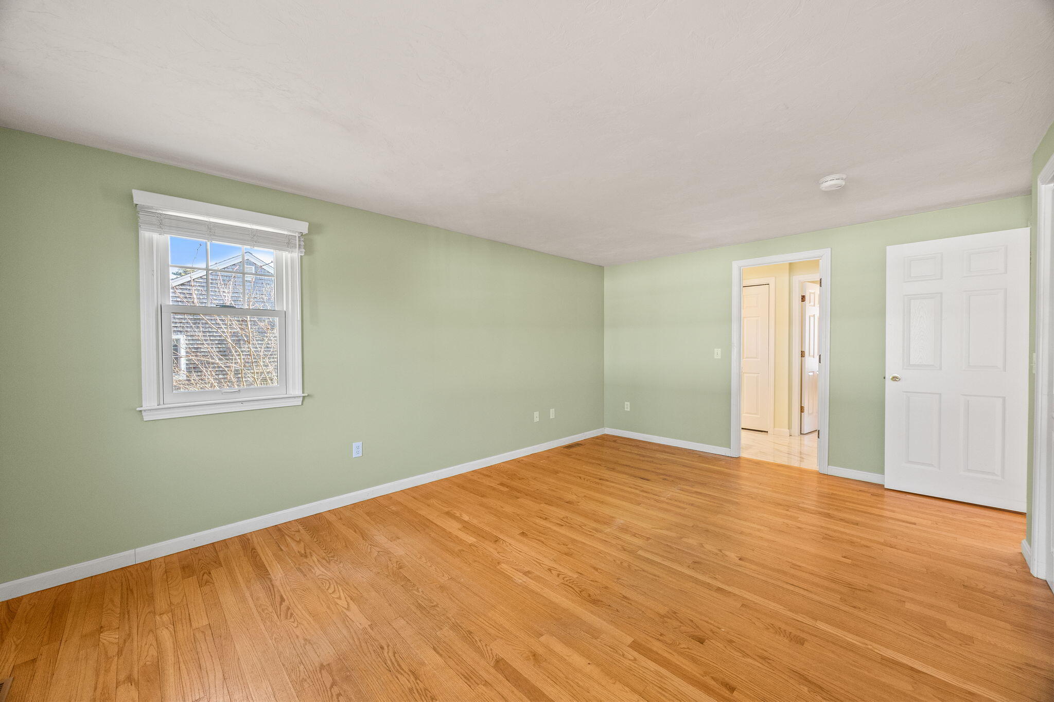 84 Middle Road South Chatham, MA 02659 - Photo 20 of 48 a view of an empty room with wooden floor and a window
