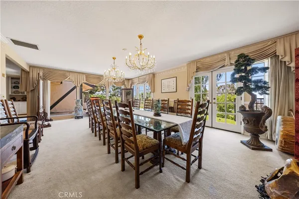 a view of a livingroom with furniture and a chandelier