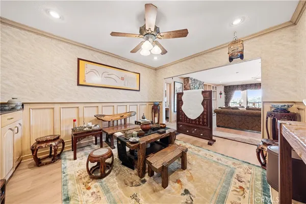 a living room with furniture gym equipment and a chandelier