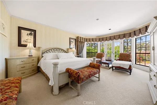a spacious bedroom with a bed and a couch
