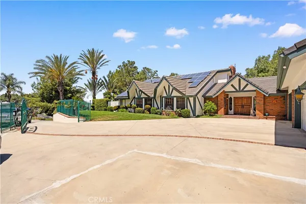 a front view of house with yard and outdoor seating