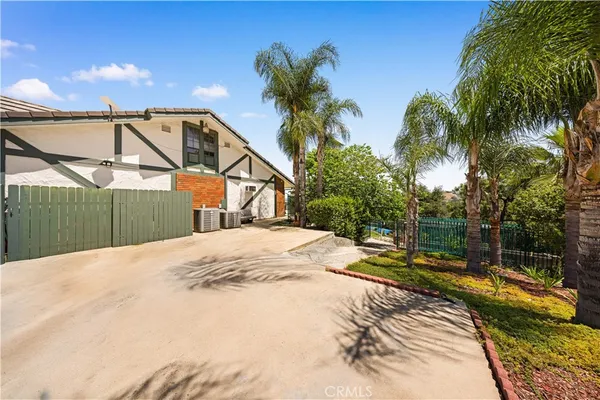 a view of a house with a garden and plants