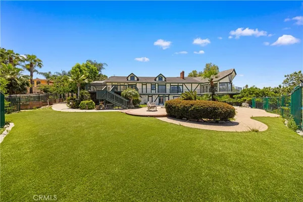 an aerial view of residential houses with outdoor space and trees