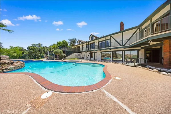 an aerial view of residential house with yard and parking space