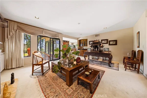 a view of a livingroom with furniture and a window