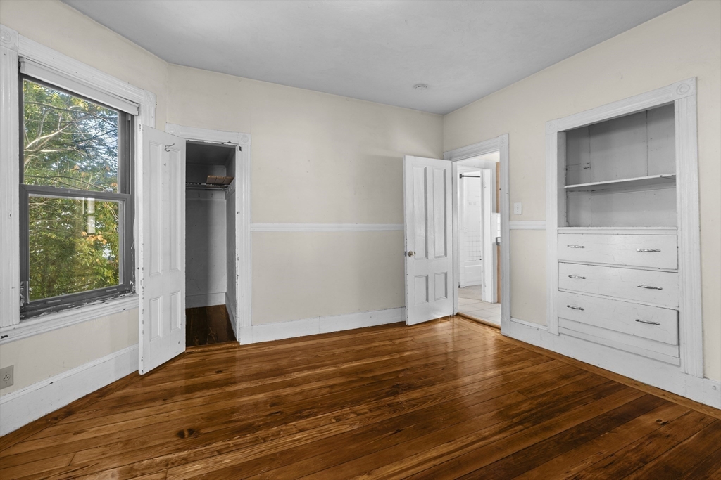 15-17 Cushman Road Boston, MA 02135 - Photo 18 of 27 a view of a room with wooden floor and cabinet