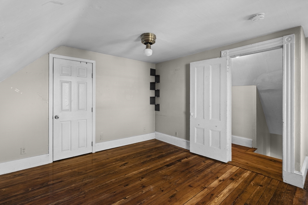 15-17 Cushman Road Boston, MA 02135 - Photo 19 of 27 wooden floor in an empty room with a window