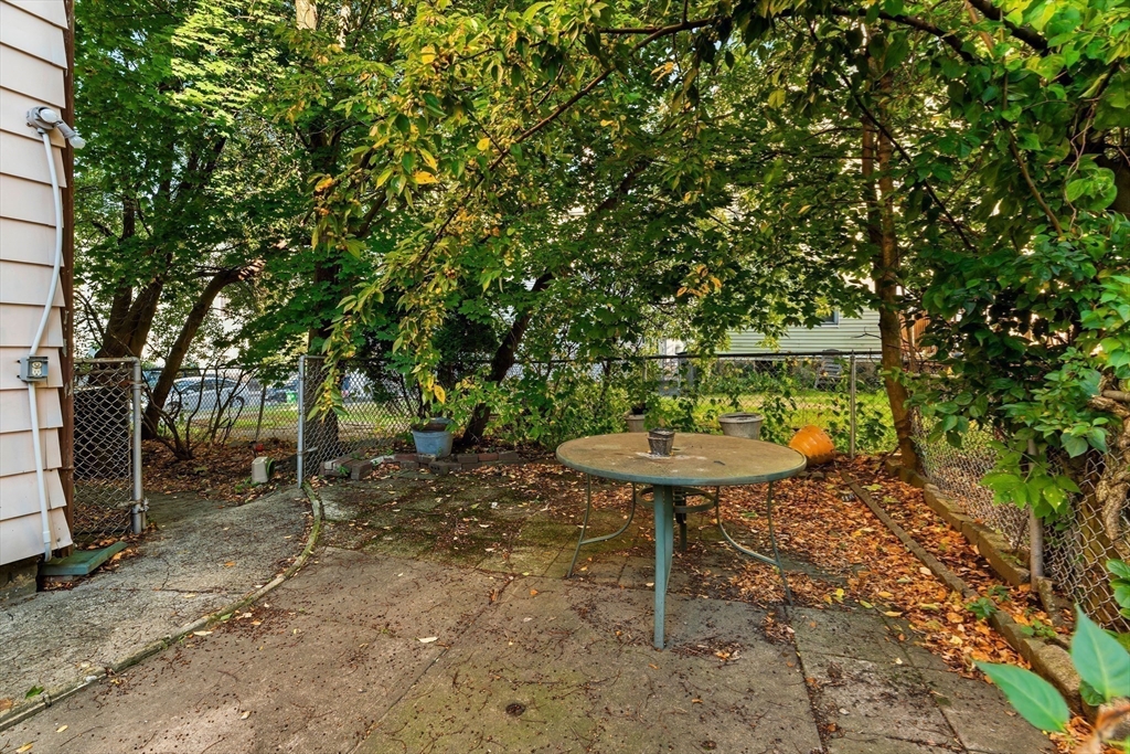 15-17 Cushman Road Boston, MA 02135 - Photo 24 of 27 a view of a backyard with table and chairs with a tree