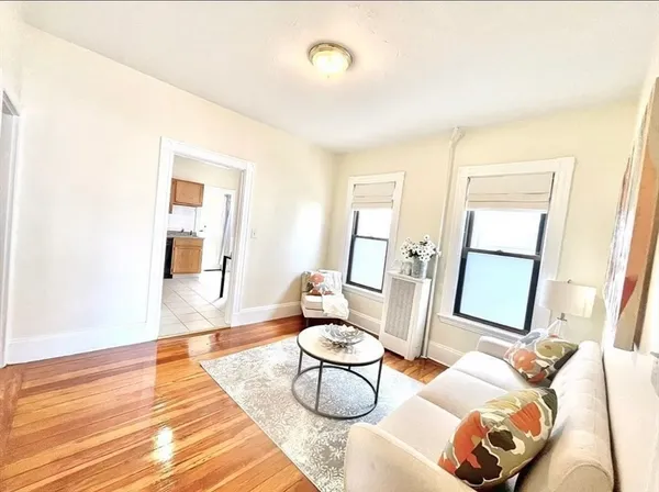 a living room with furniture and a rug