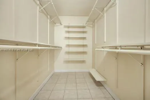 a view of walk in closet with empty racks